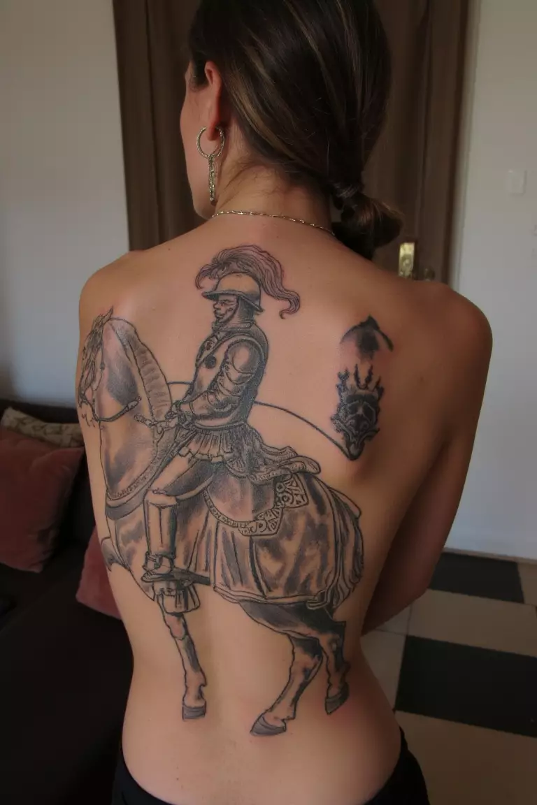 Unfinished Vintage Knight And Horse Tattoo A photo of a woman with an unfinished vintage knight riding a horse tattoo, living room background.