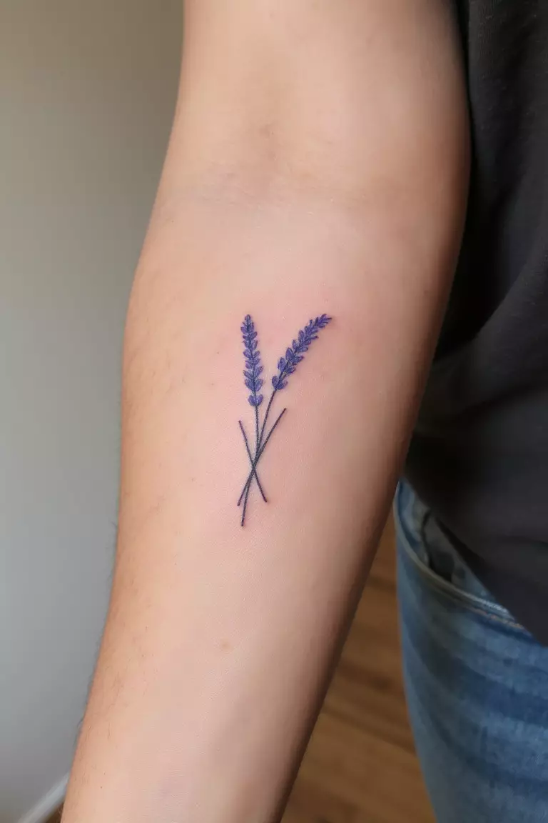 Minimalist Lavender Silhouette A close up shot of woman's arm with a minimalist lavender silhouette tattoo