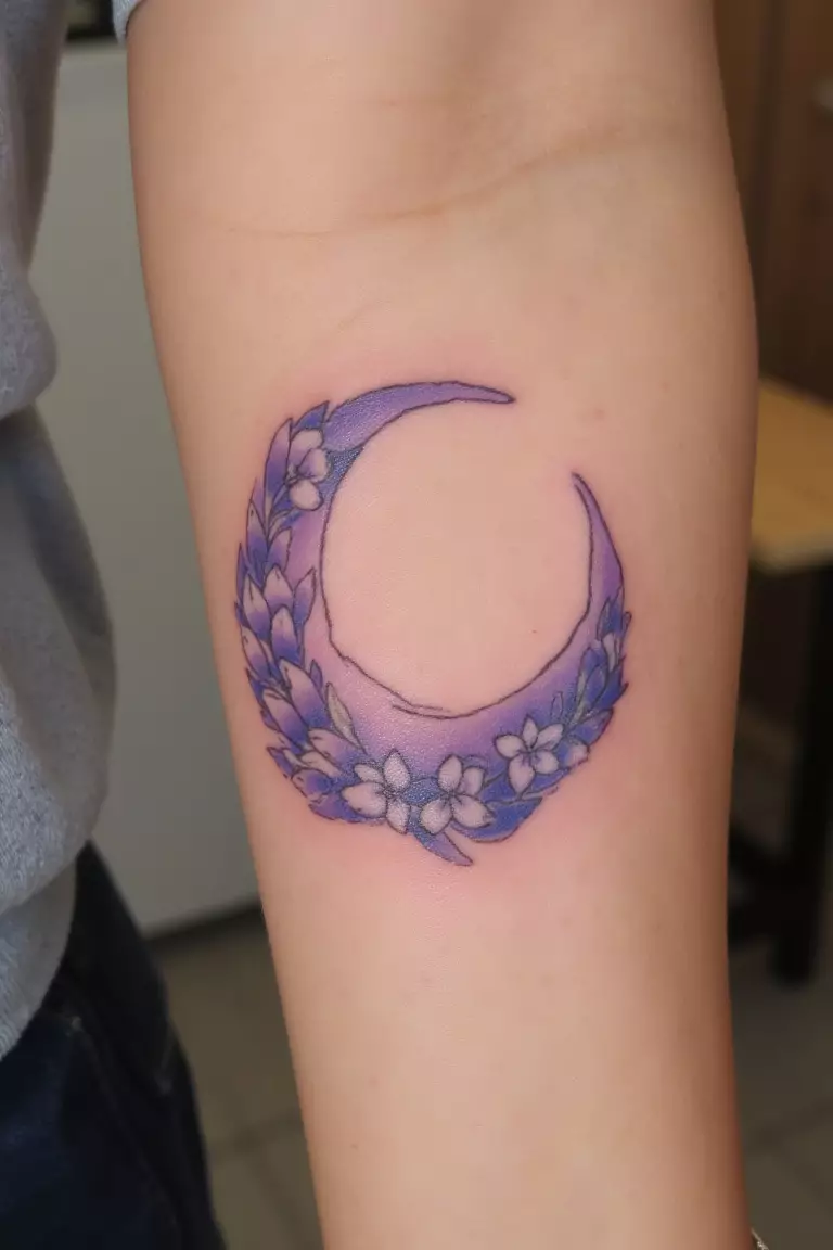 Lavender Crescent Moon A close up shot of woman's arm with a lavender crescent moon tattoo