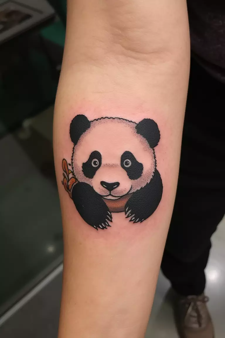 Single Needle Baby Panda Tattoo on Forearm A close up shot of woman with a single needle baby panda tattoo on her forearm.