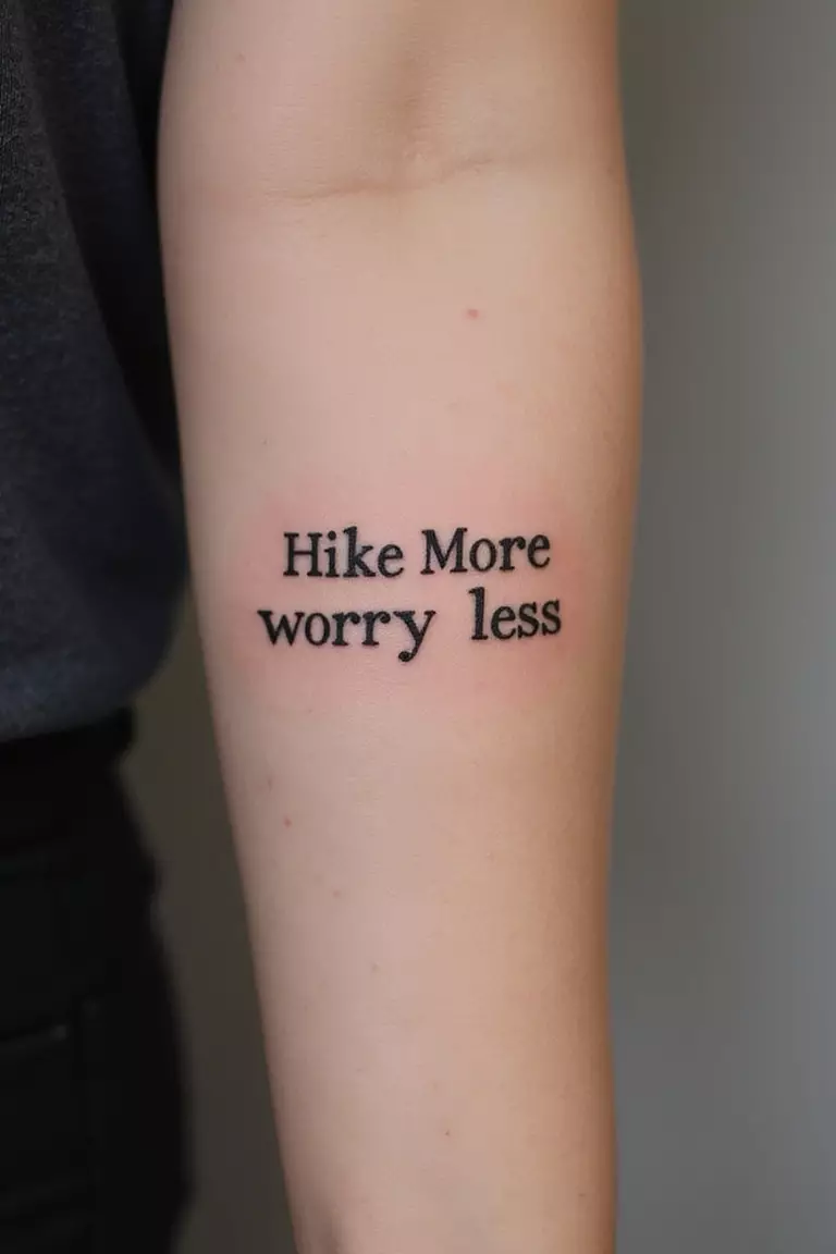 Hike More Worry Less Text A close-up shot of a woman showing her black ink simple text