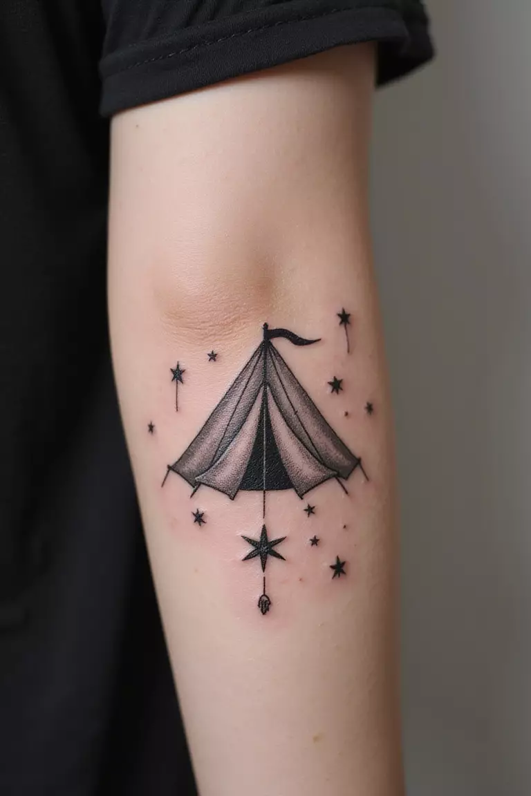 Tent Under Stars A close-up shot of a woman showing her black ink tent under stars tattoo design on her arm