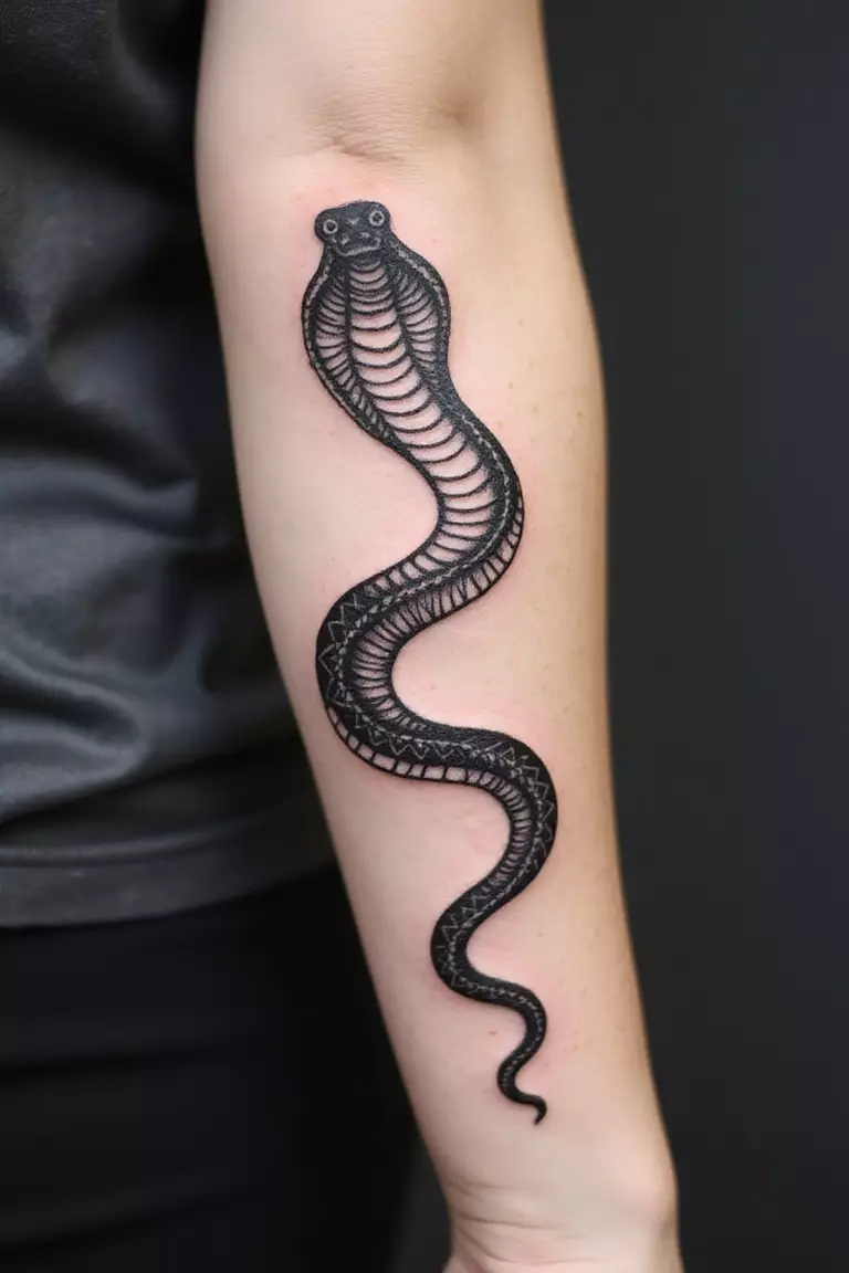 Geometric Snake A close-up shot of a woman showing her black ink geometric snake tattoo design on her arm, mixing sharp angles and straight lines to form the snake.