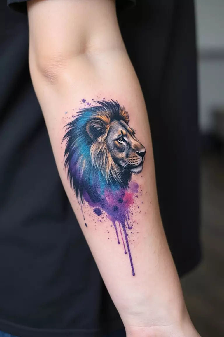 Watercolor Splash Lion A close-up shot of a woman's arm with a black ink tattoo of a lion's silhouette filled with vibrant watercolor splashes in blue, purple, and pink.